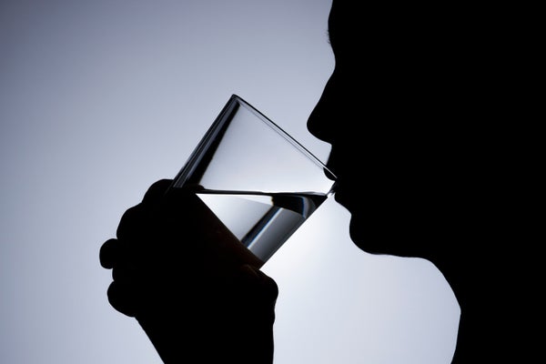 A woman drinking water from a glass