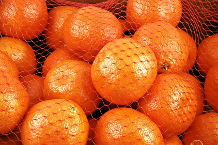 Clementines in an orange net.