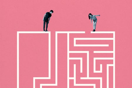 Young man and woman standing on top of white maze against pink background