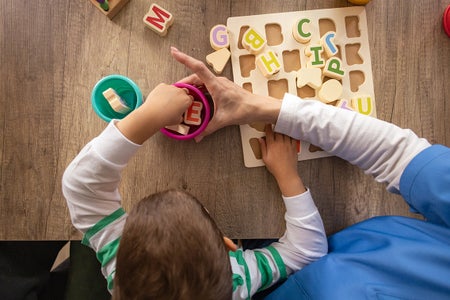 Nurse helps boy with autism learn letters