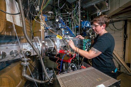 A researcher at the Lawrence Berkeley National Laboratory works with a cyclotron and associated equipment for synthesizing new elements of the periodic table